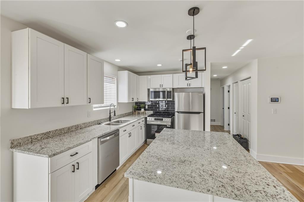 3822 Stephanie Drive Southwest Atlanta, GA 30331 - Photo 7 of 28 a kitchen with stainless steel appliances granite countertop a sink stove and refrigerator