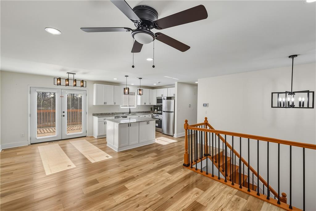 3822 Stephanie Drive Southwest Atlanta, GA 30331 - Photo 8 of 28 a open kitchen with stainless steel appliances granite countertop a refrigerator a stove a microwave oven cabinets and wooden floor