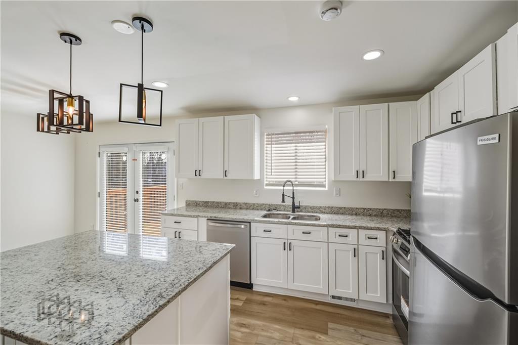 3822 Stephanie Drive Southwest Atlanta, GA 30331 - Photo 9 of 28 a kitchen with stainless steel appliances granite countertop a sink stove and refrigerator