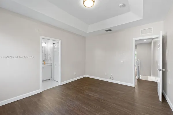 a view of a room with wooden floor