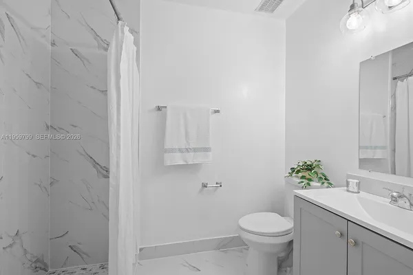 a bathroom with a sink toilet and a mirror