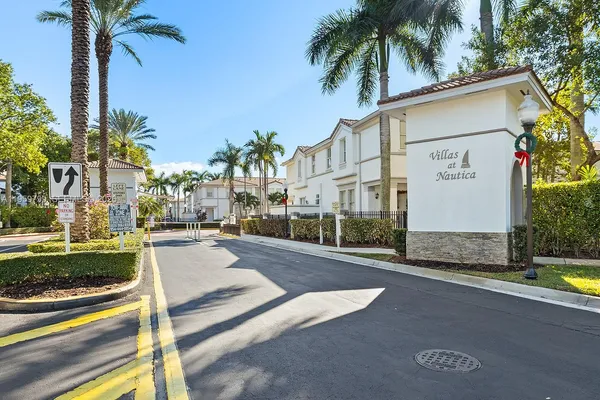a view of a street with palm trees