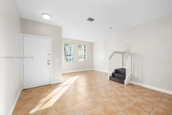 a view of an empty room with a window