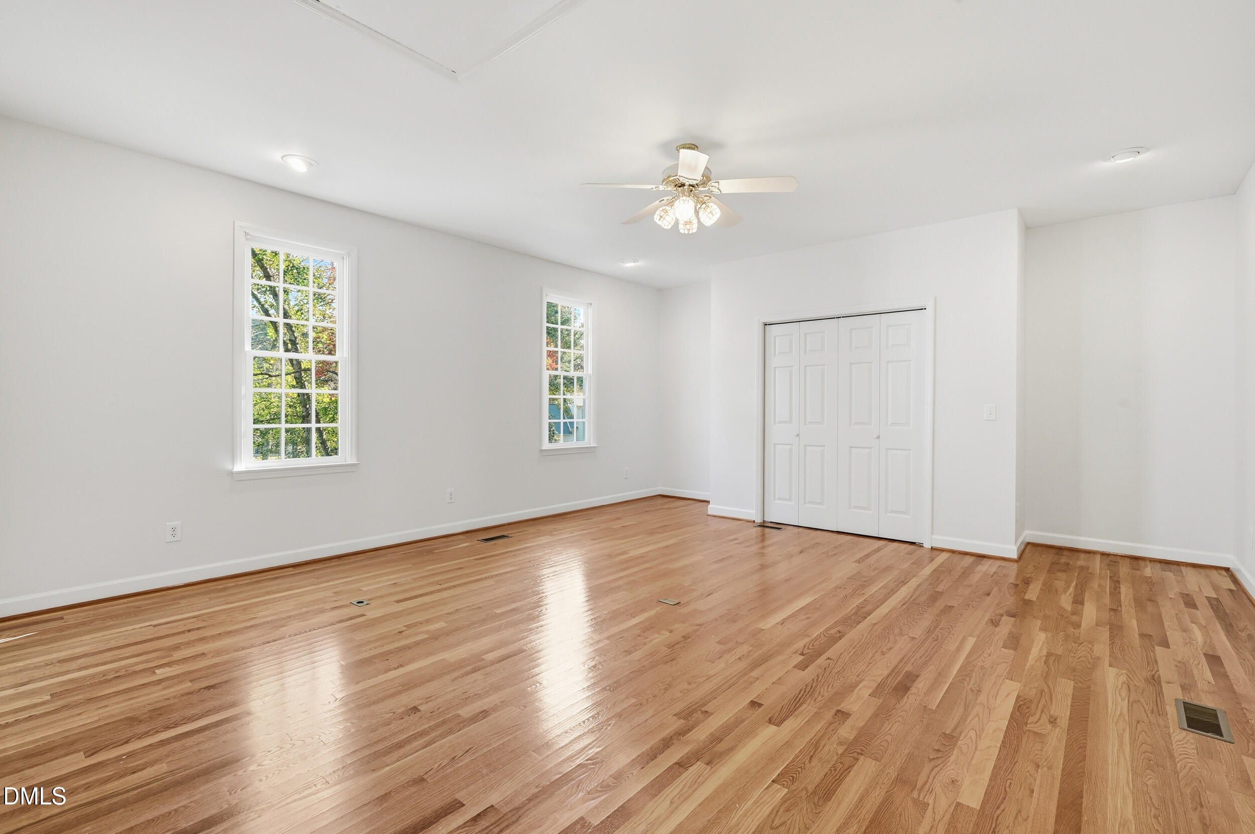 4 Wembley Court Durham, NC 27705 - Photo 24 of 41 an empty room with wooden floor chandelier fan and windows