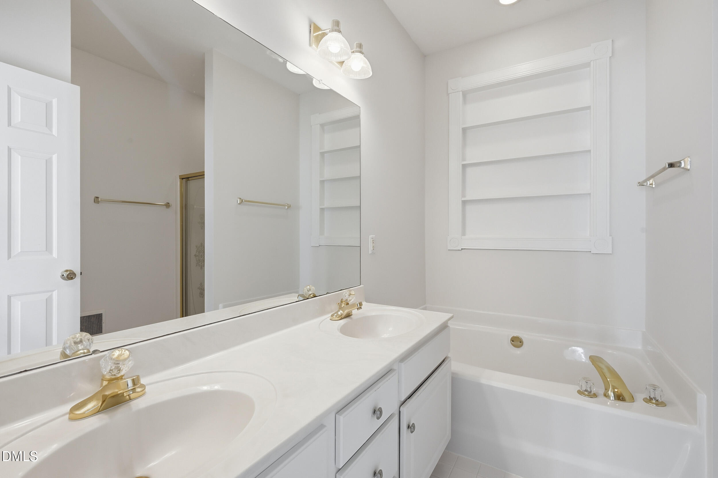 4 Wembley Court Durham, NC 27705 - Photo 37 of 41 a bathroom with a tub a sink and mirror