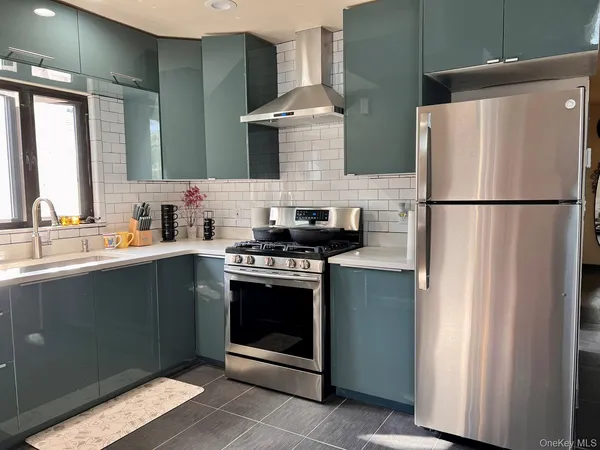 a kitchen with stainless steel appliances a refrigerator sink and cabinets