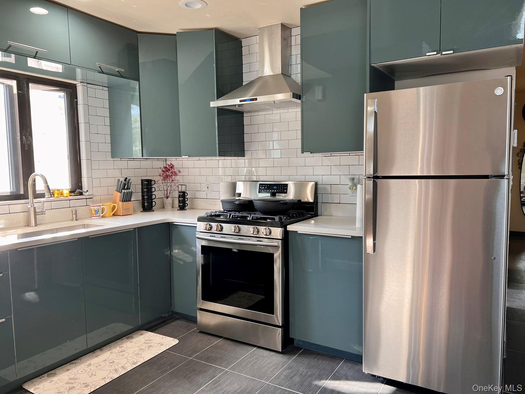 147-22 Ash Avenue Queens, NY 11355 - Photo 15 of 22 a kitchen with stainless steel appliances a refrigerator sink and cabinets