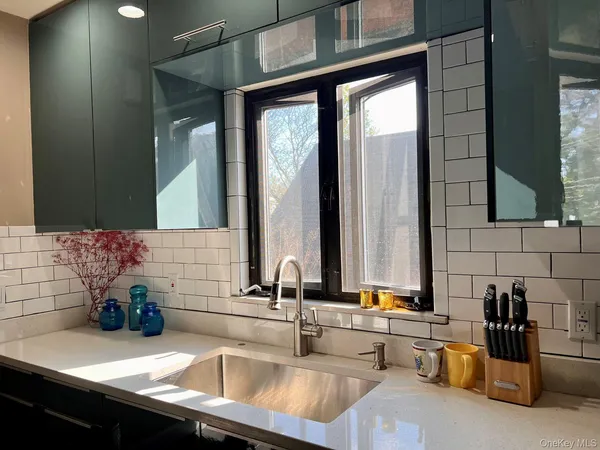 a bathroom with double vanity sinks and a bathtub