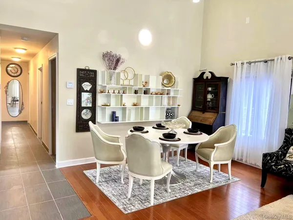 a dining room with furniture and wooden floor