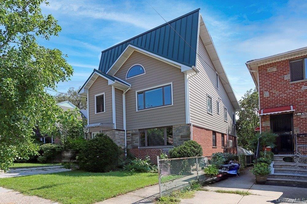 147-22 Ash Avenue Queens, NY 11355 - Photo 22 of 22 a front view of a house with a yard