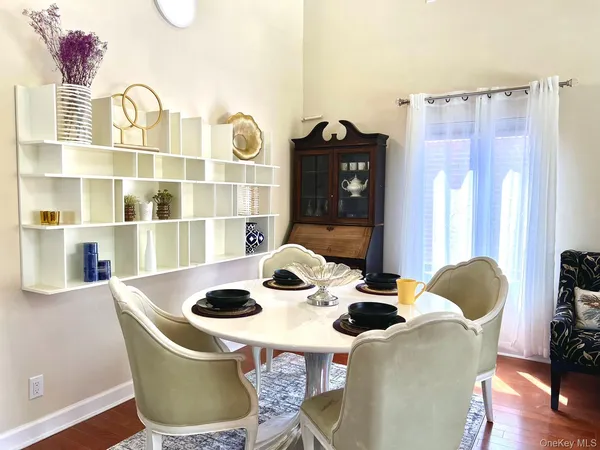 a dining room with furniture and wooden floor