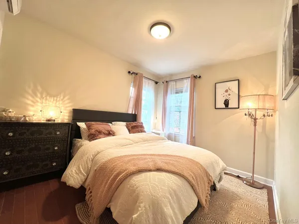 a bedroom with a bed and a night stand