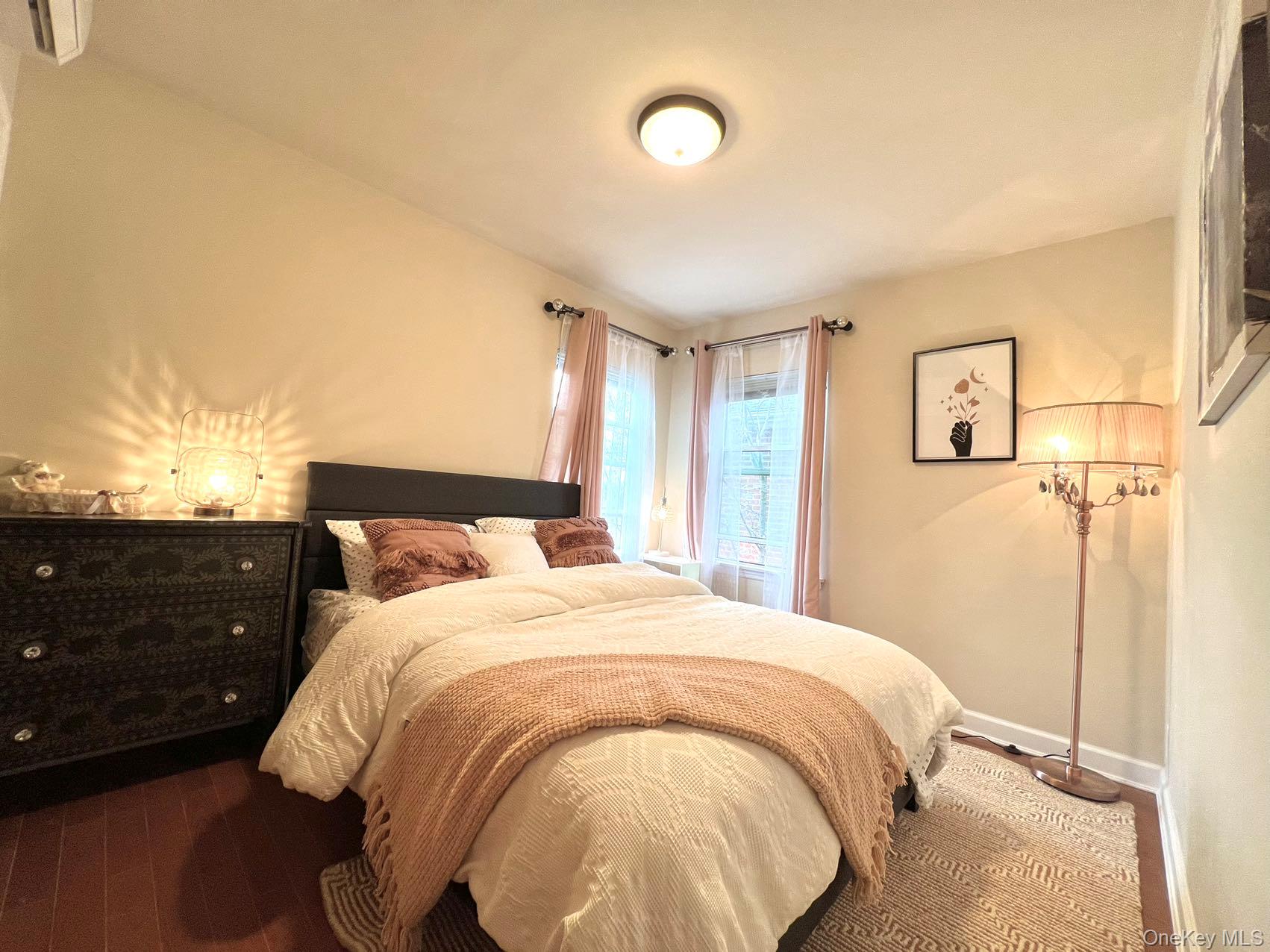 147-22 Ash Avenue Queens, NY 11355 - Photo 9 of 22 a bedroom with a bed and a night stand