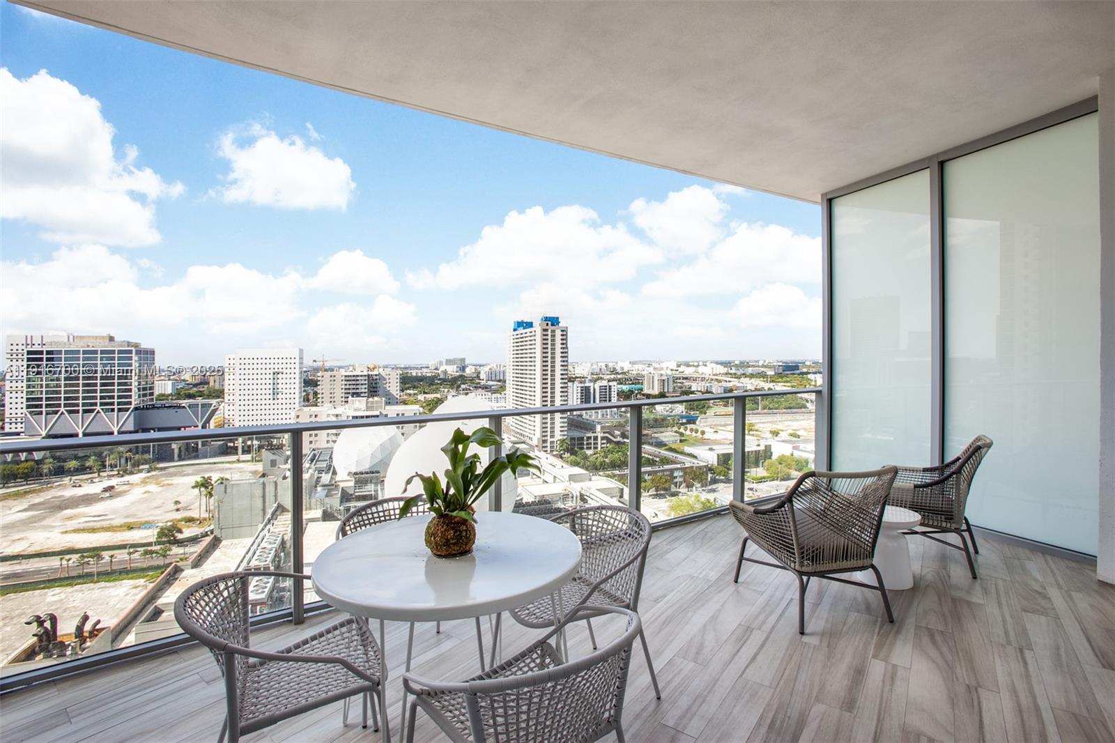 851 Northeast 1st Avenue, Unit 1810 Miami, FL 33132 - Photo 11 of 26 a balcony with furniture and a view of lake