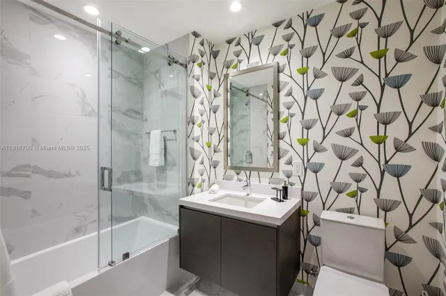 a bathroom with a sink mirror and shower