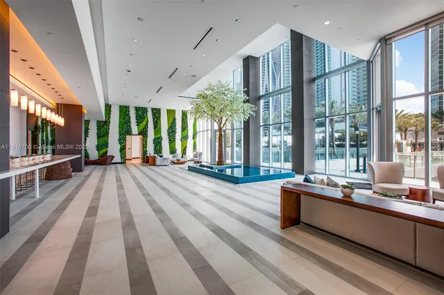 a lobby with furniture and large windows