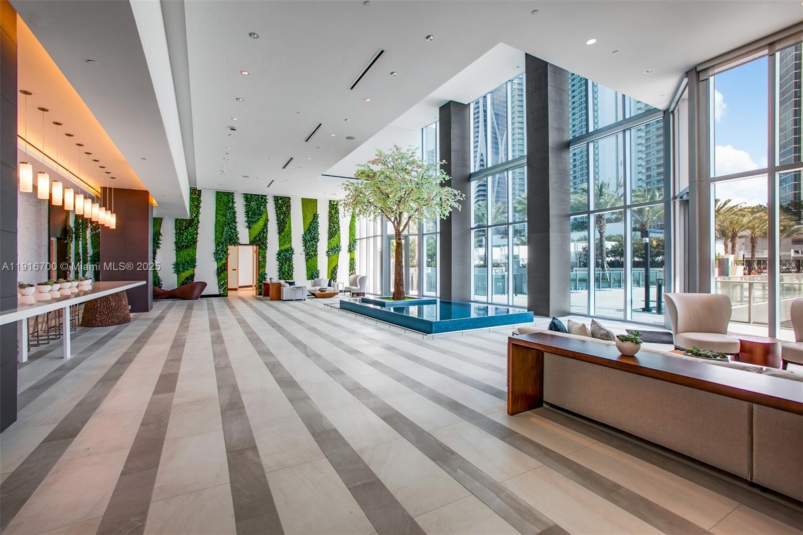 851 Northeast 1st Avenue, Unit 1810 Miami, FL 33132 - Photo 17 of 26 a lobby with furniture and large windows