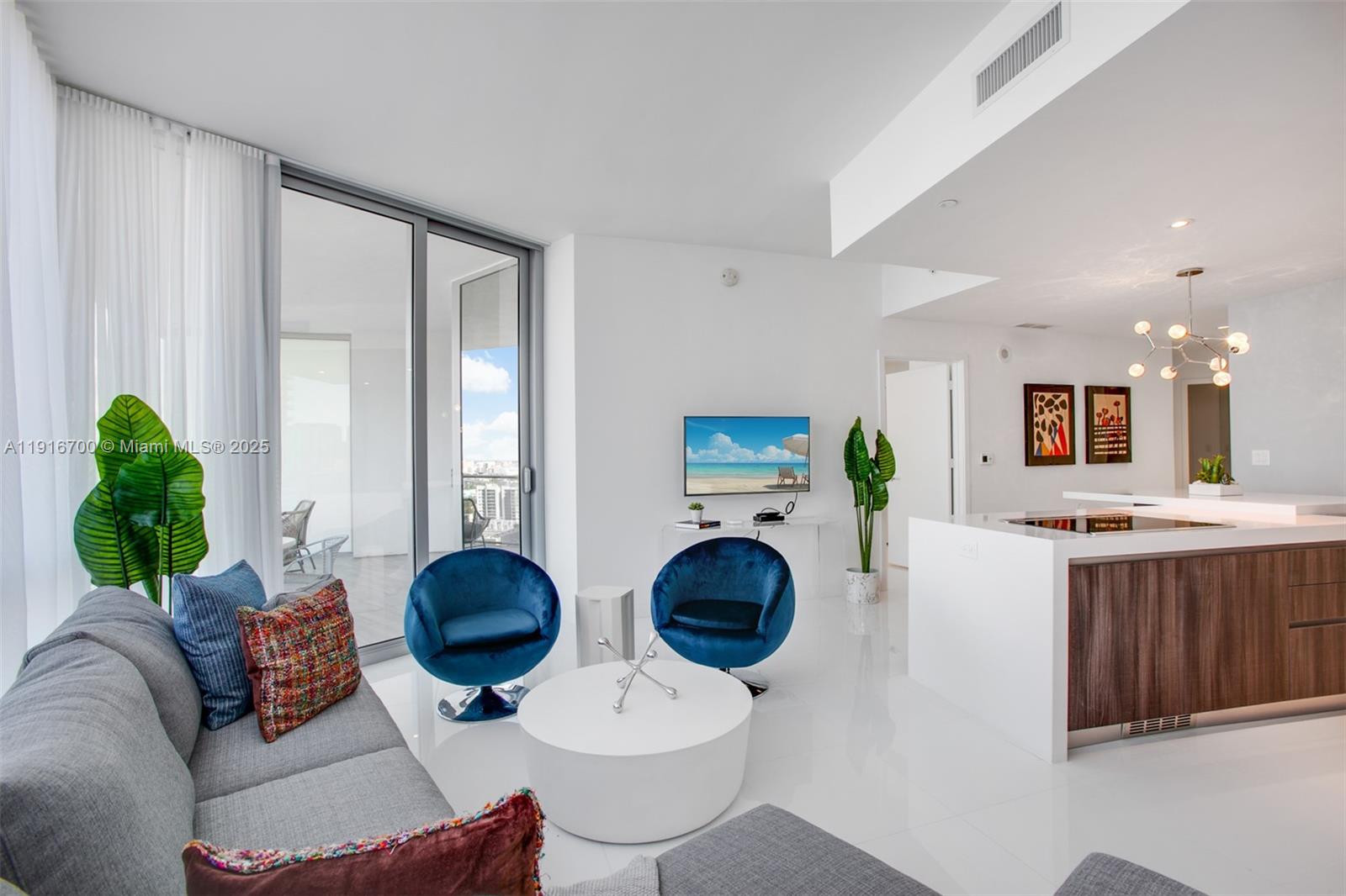 851 Northeast 1st Avenue, Unit 1810 Miami, FL 33132 - Photo 5 of 26 a living room with furniture a flat screen tv and a large window