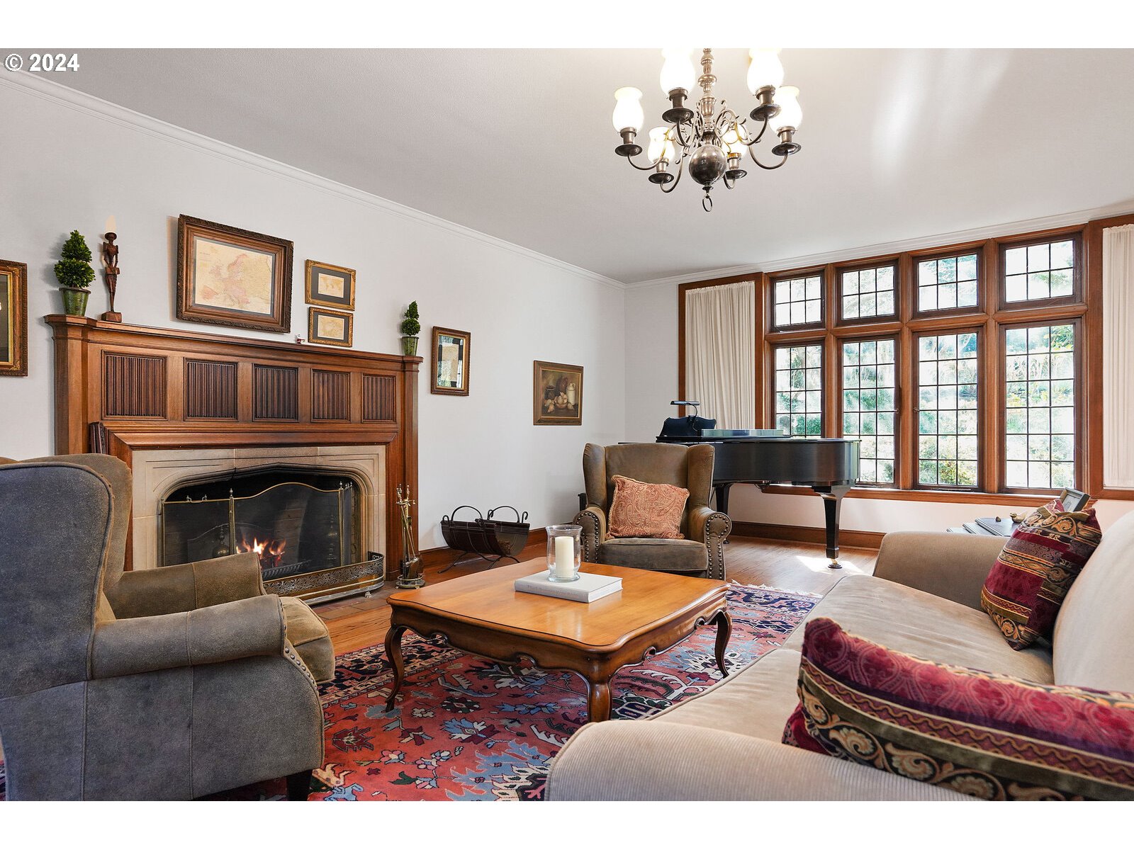460 Leffelle Street South Salem, OR 97302 - Photo 4 of 48 a living room with furniture a chandelier a fireplace and a large window