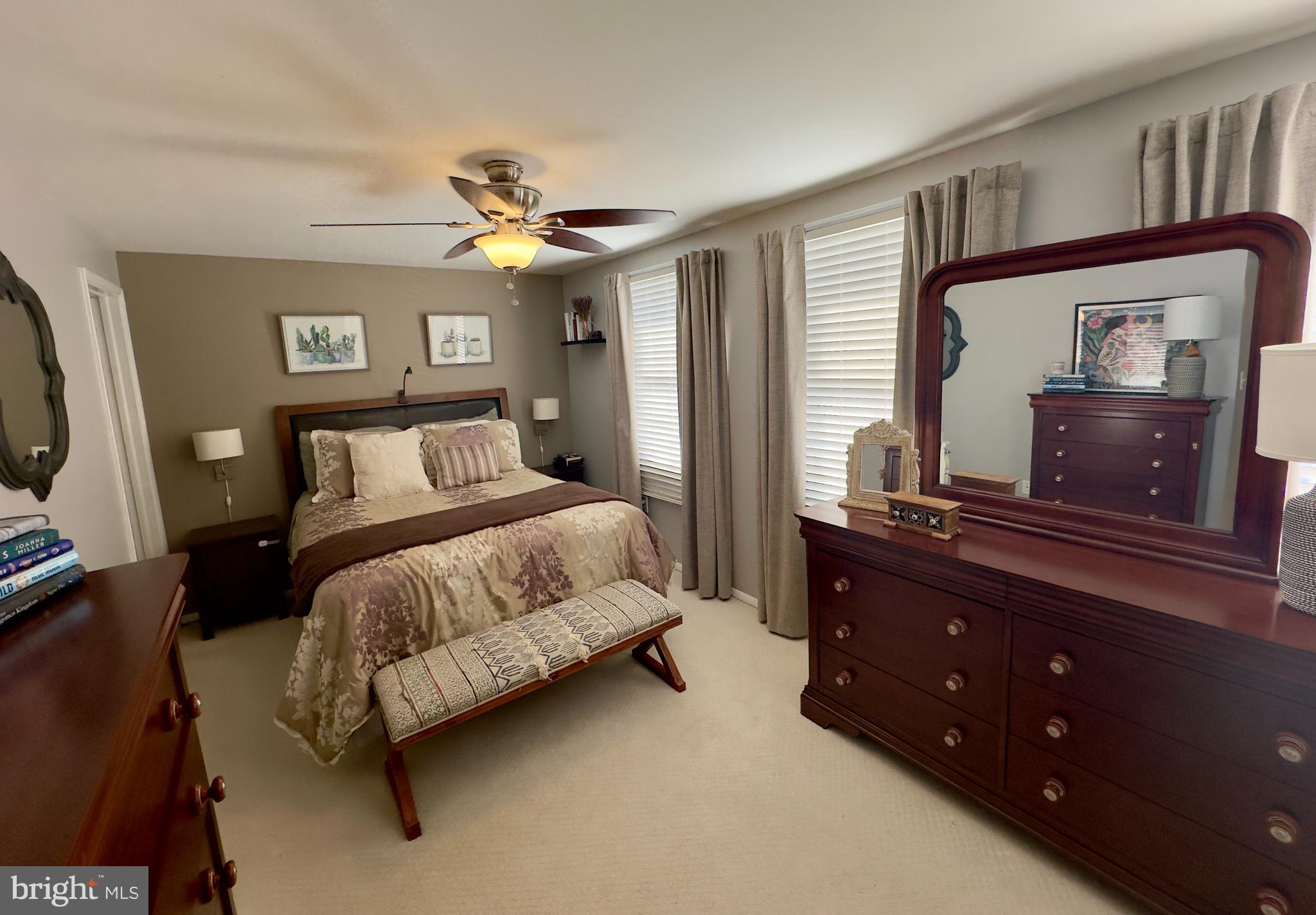 19829 Wheelwright Drive Gaithersburg, MD 20886 - Photo 25 of 35 a bedroom with a bed and a dresser with mirror