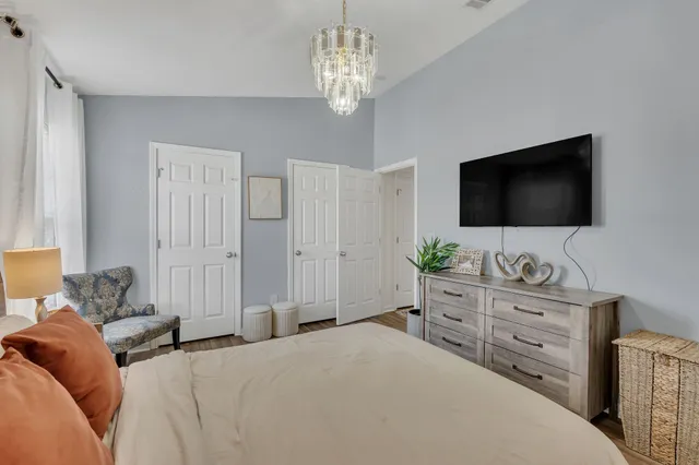 a bedroom with a bed and a flat screen tv