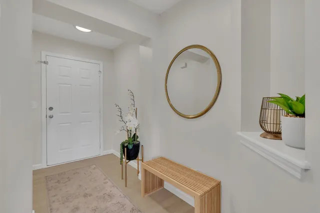 a living room with furniture and a potted plant