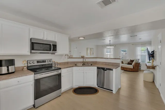 a kitchen with a sink stove and microwave
