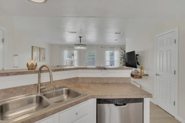 a kitchen with a sink and a refrigerator