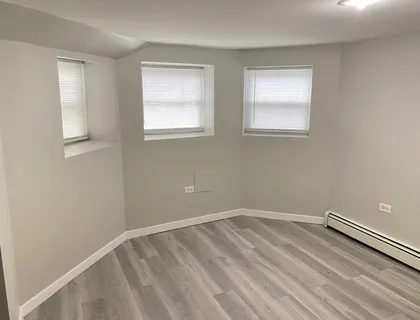 a view of a room with wooden floor and window