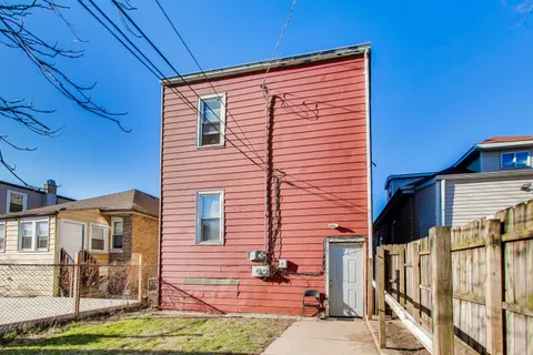a view of a house with a yard and garage