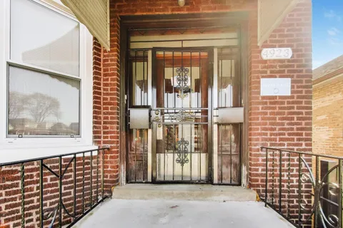 a view of a brick house with a large window
