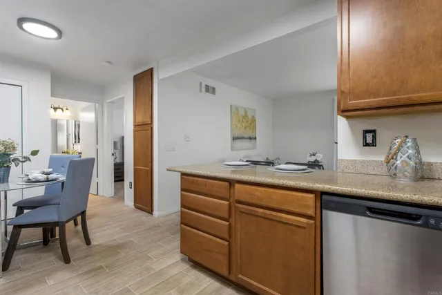 a kitchen with stainless steel appliances granite countertop a sink and a refrigerator