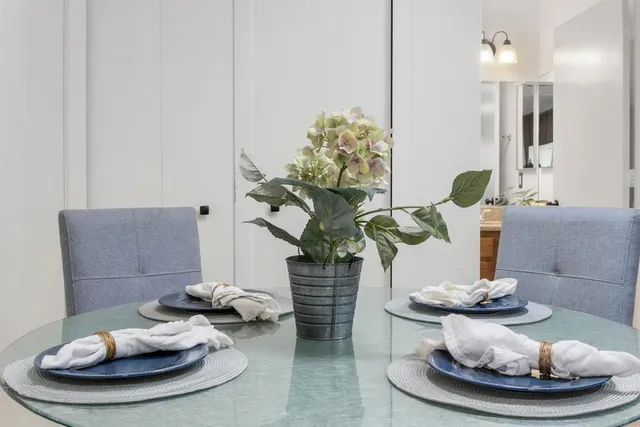 a vase of flowers sitting on a dining table