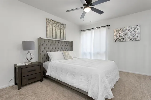 a bedroom with a bed and window