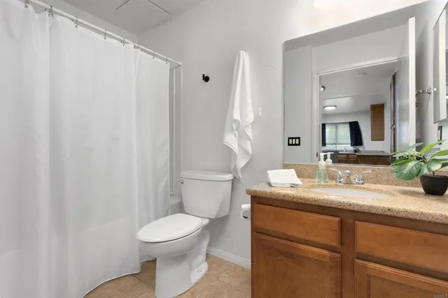 a bathroom with a toilet a sink and a mirror