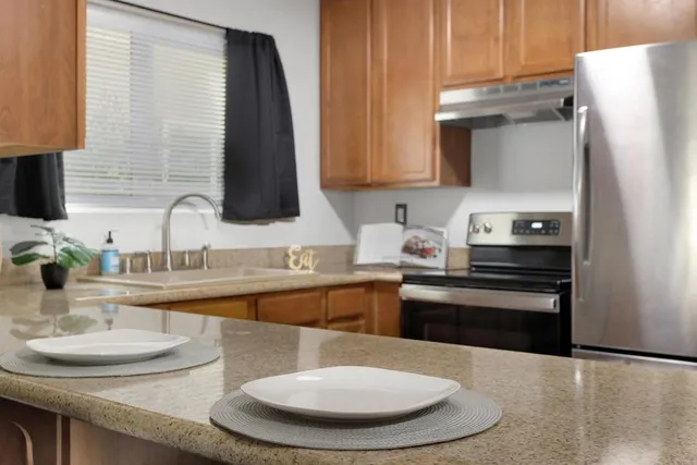 a kitchen with stainless steel appliances a sink and a stove
