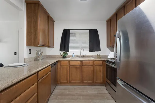 a bathroom with a granite countertop sink a mirror and shower