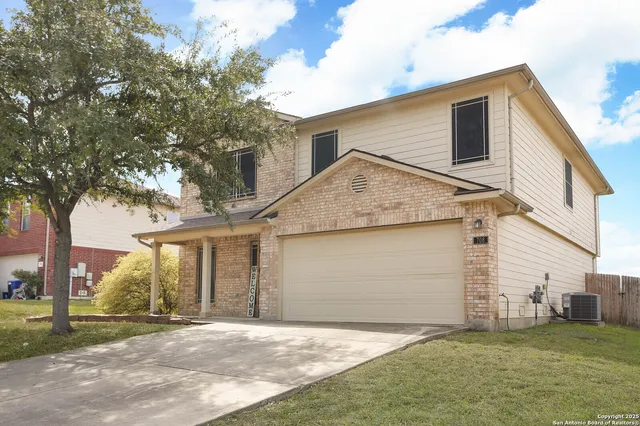 a view of a house with a yard and garage