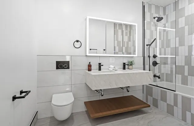 a bedroom with a large bed and a potted plant