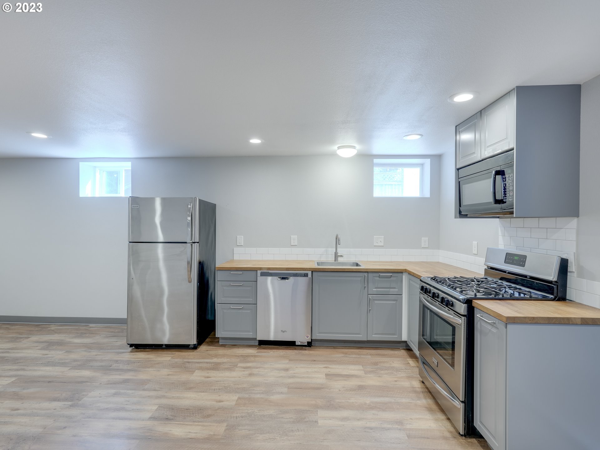 6676 North Mears Street Portland, OR 97203 - Photo 14 of 21 a kitchen with stainless steel appliances granite countertop a refrigerator a sink and a stove