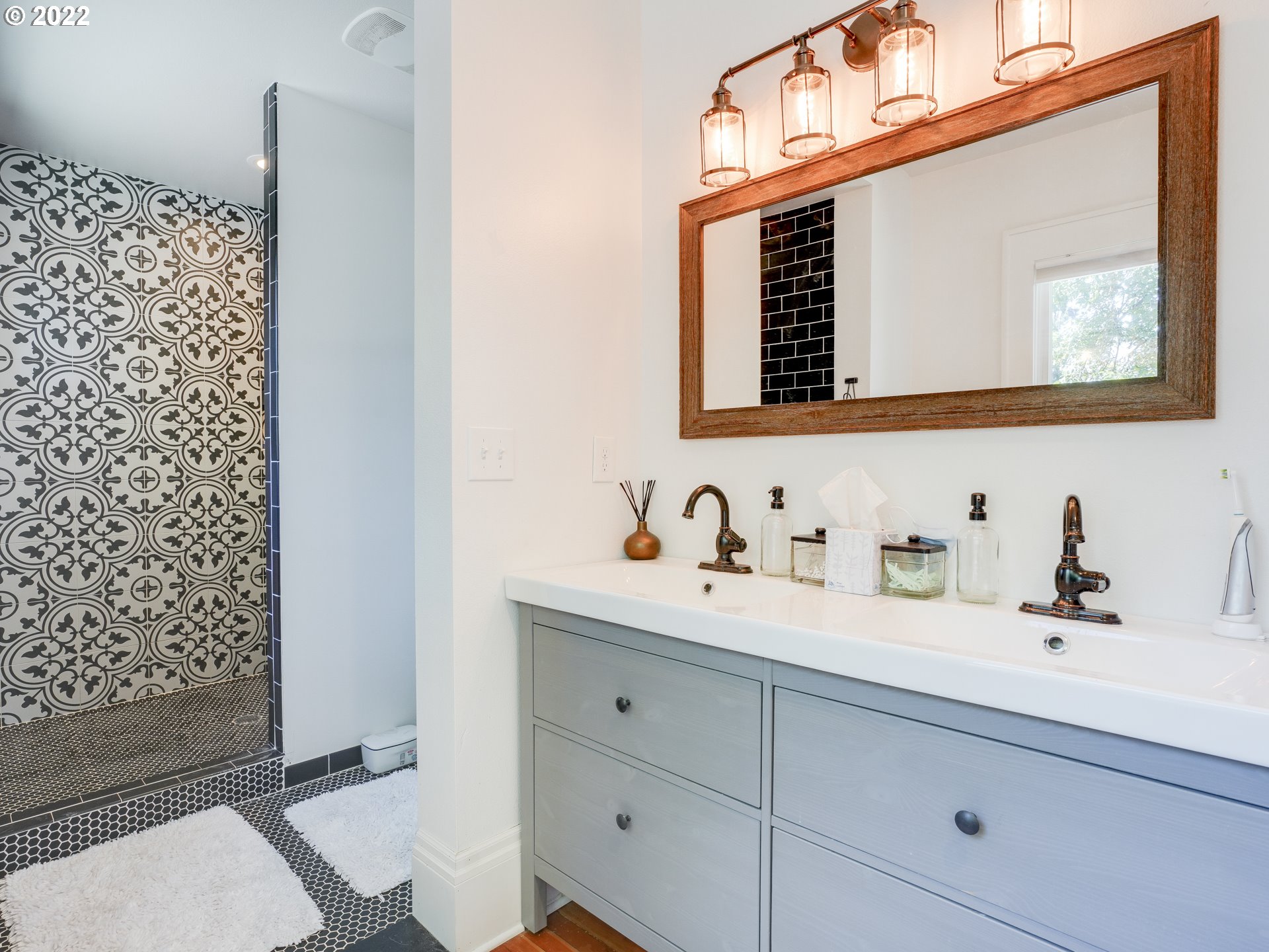 6676 North Mears Street Portland, OR 97203 - Photo 6 of 21 a bathroom with a sink a mirror and shower