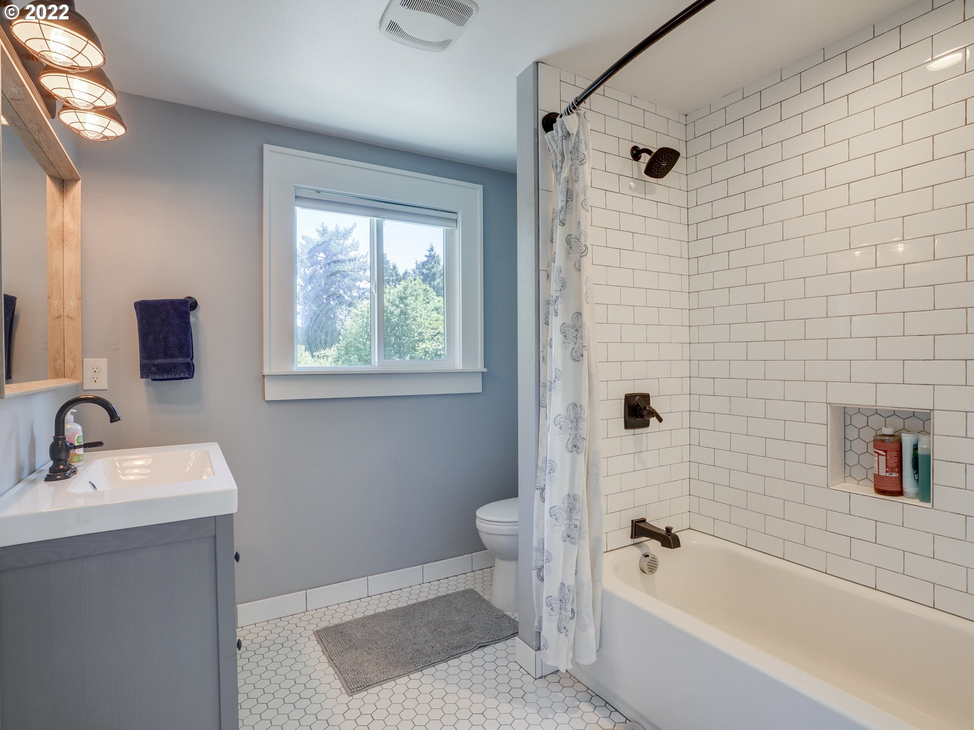 6676 North Mears Street Portland, OR 97203 - Photo 9 of 21 a bathroom with a bathtub shower sink vanity and a toilet
