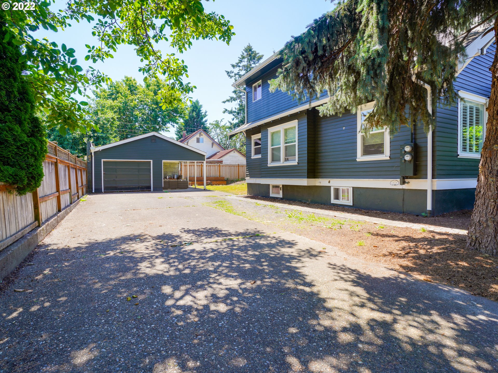 6676 North Mears Street Portland, OR 97203 - Photo 10 of 21 a front view of a house with a yard and large trees