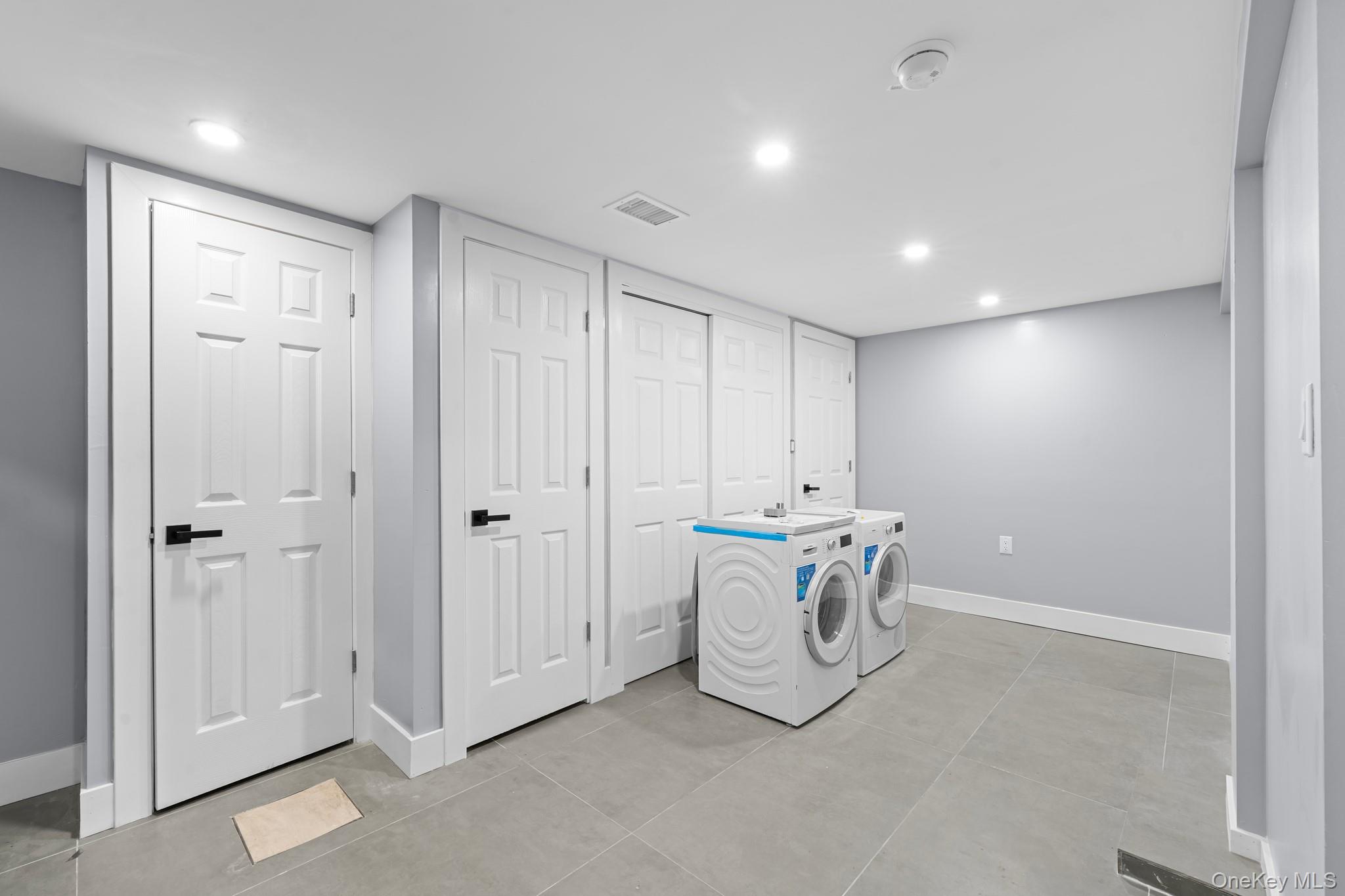 111-32 199th Street Queens, NY 11412 - Photo 13 of 19 Washroom with independent washer and dryer, recessed lighting, and light tile patterned floors