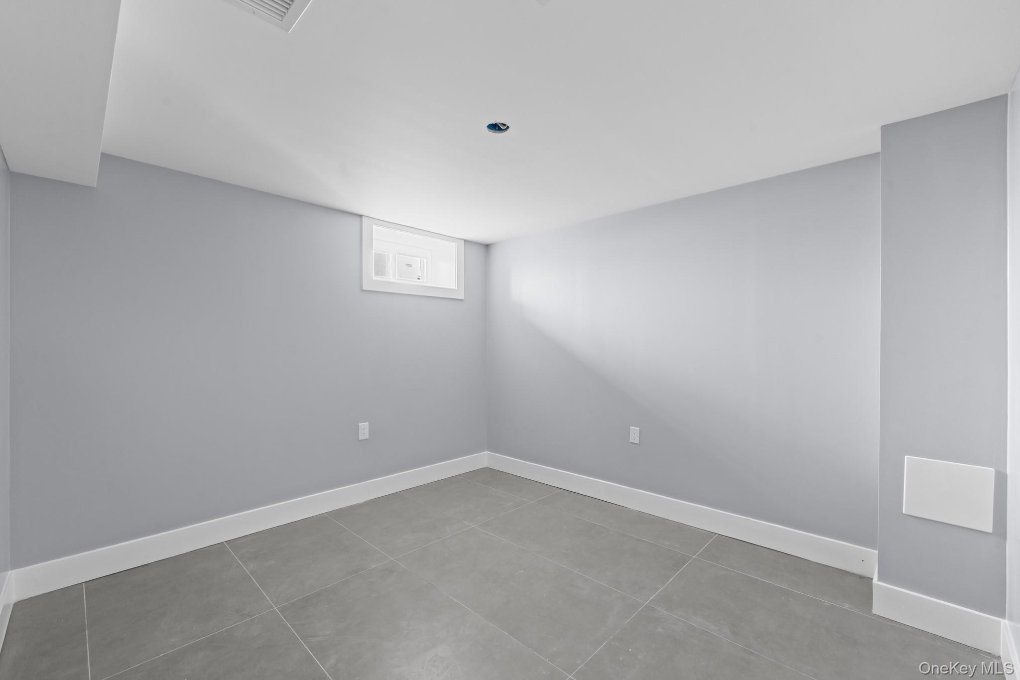 111-32 199th Street Queens, NY 11412 - Photo 14 of 19 Spare room with baseboards and light tile patterned floors