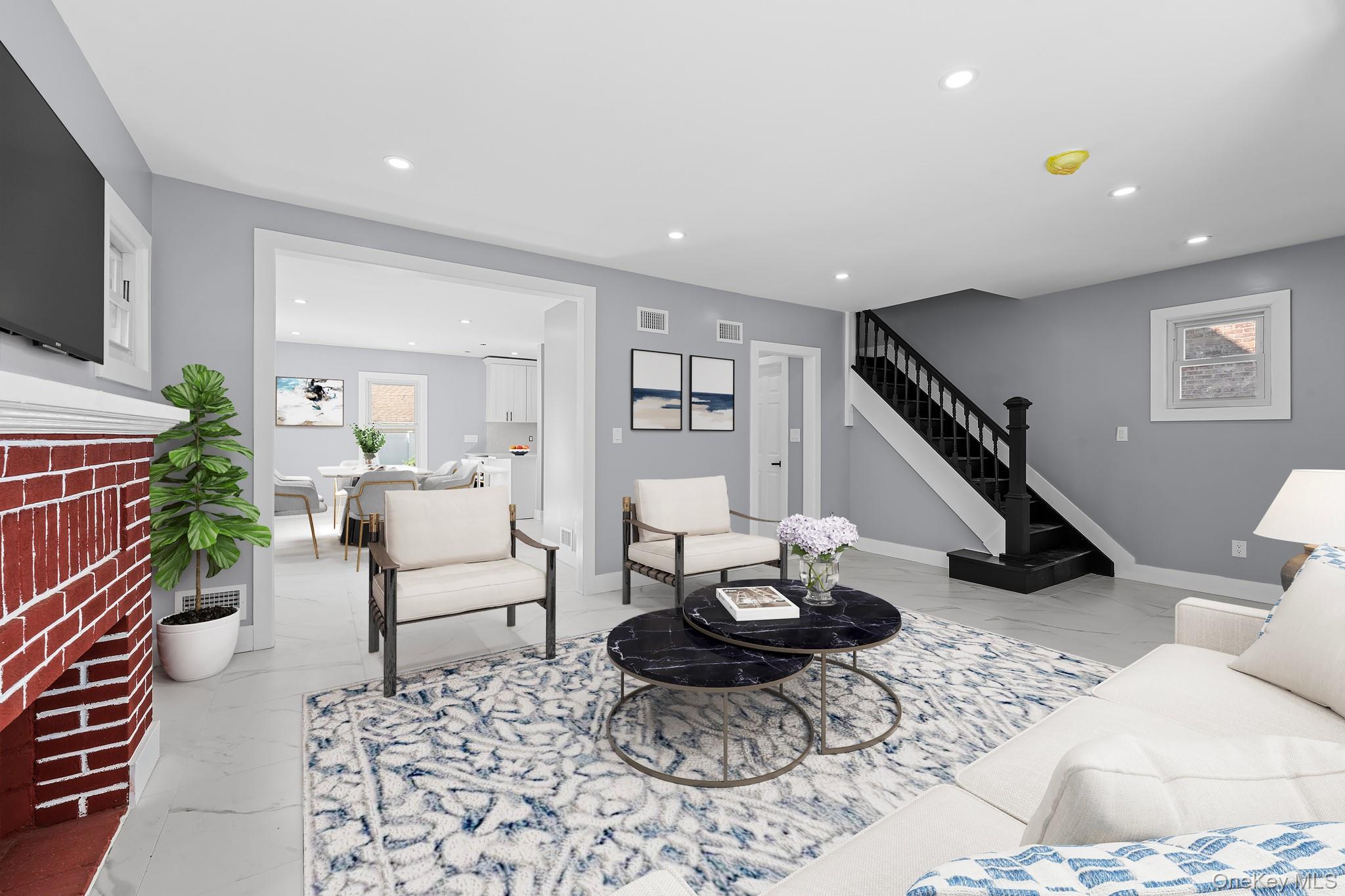 111-32 199th Street Queens, NY 11412 - Photo 4 of 19 Living area with light marble finish flooring, recessed lighting, stairway, and a fireplace