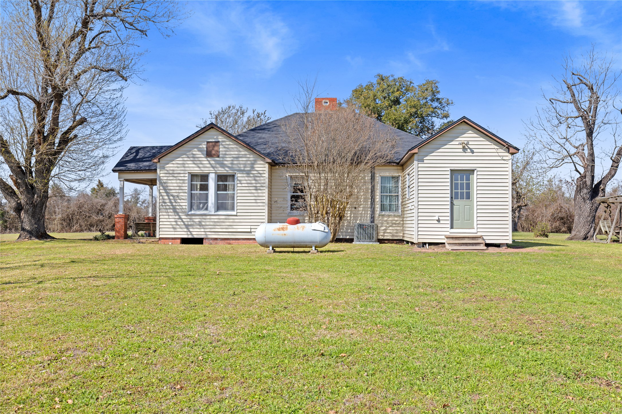 18218 Buck Road Washington, TX 77880 - Photo 24 of 32 a front view of a house with a garden and trees