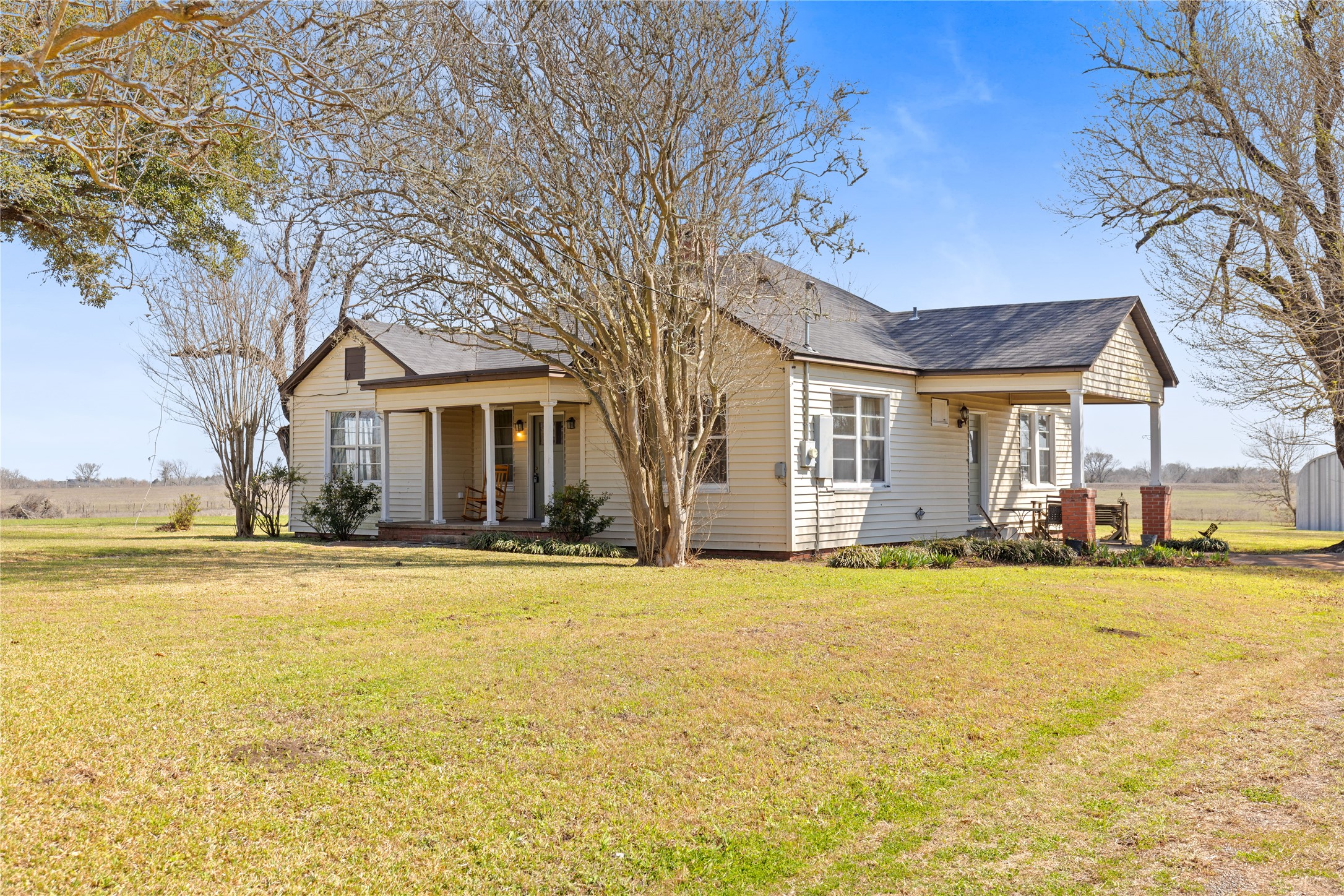 18218 Buck Road Washington, TX 77880 - Photo 3 of 32 a view of a large pool with a lawn chairs under palm trees