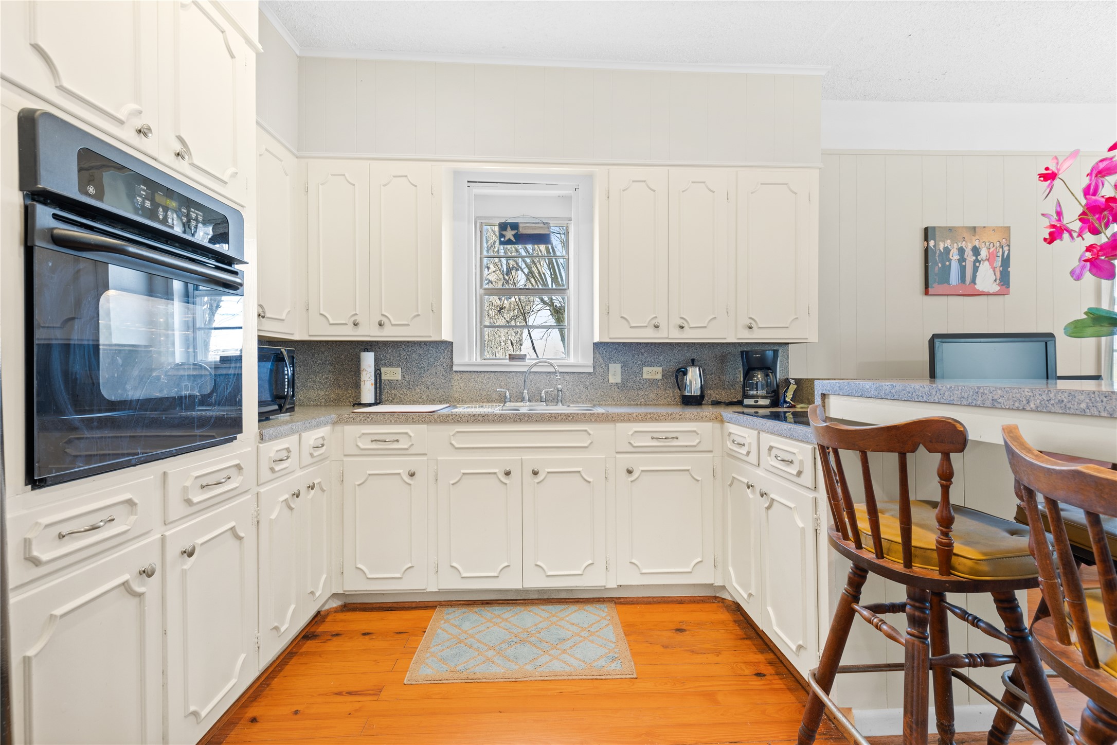 18218 Buck Road Washington, TX 77880 - Photo 9 of 32 a large kitchen with granite countertop a stove a sink and a microwave
