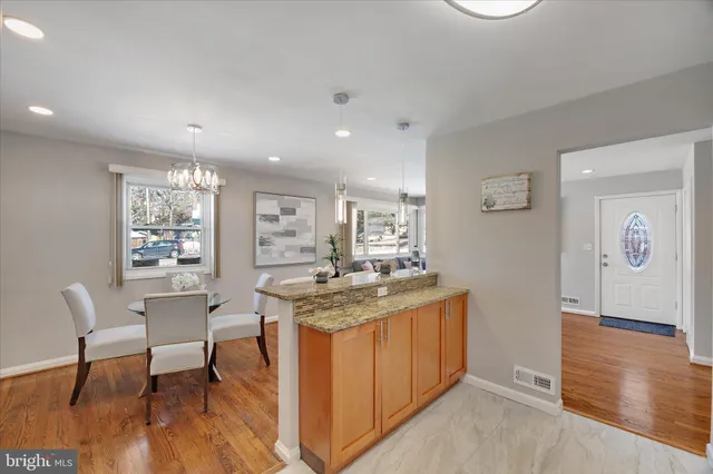 a kitchen with stainless steel appliances granite countertop a stove and a refrigerator